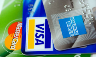 an assortment of business credit cards, including a Visa, Mastercard, and American Express