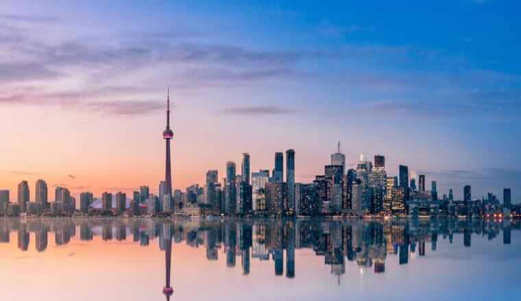 A beautiful pastel sky over the downtwon skyline of Toronto, Ontario on the shore of Lake Ontario