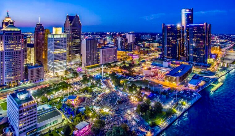The towering downtown skyline of Detroit, Michigan lit up during the evening