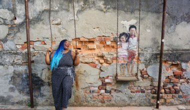 Annette posing near a mural in Penang