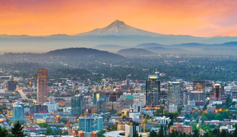 the skyline of Portland, Oregon, with Mt Hood in the background, at sunset