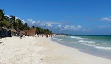 A wide beach on a sunny day in Tulum, Mexico