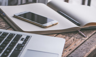 a laptop notebook and smartphone on a desk