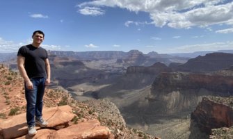 Nomadic Matt standing at the edge of the Grand Canyon