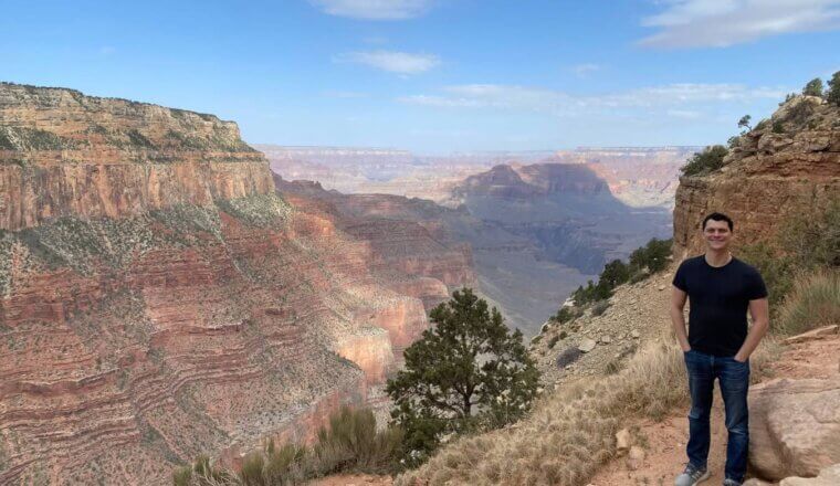 Nomadic Matt posing in front of the Grand Canyon