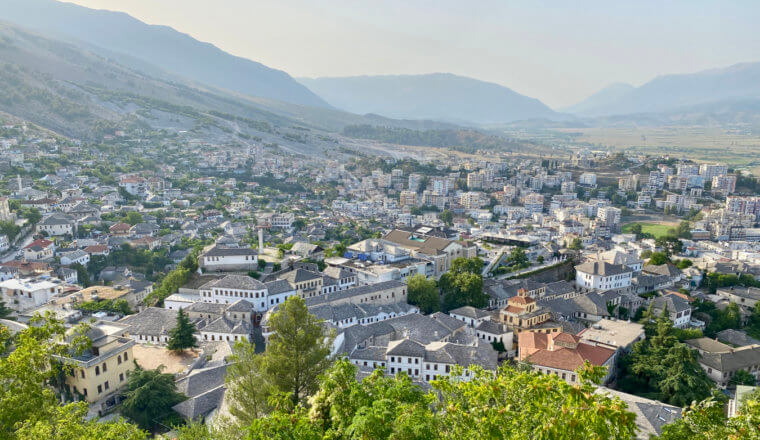 The view overlooking a small town in Albania surrounded by lush mountain