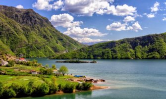 A serene lake surrounded by lush greenery in Albania