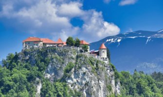 The towering Lake Bled castle in Slovenia perched on a tall cliff