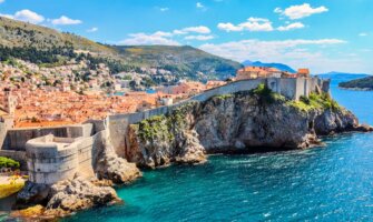 The historic old buildings of Dubrovnik, Croatia perched along the old wall near the beautiful sea