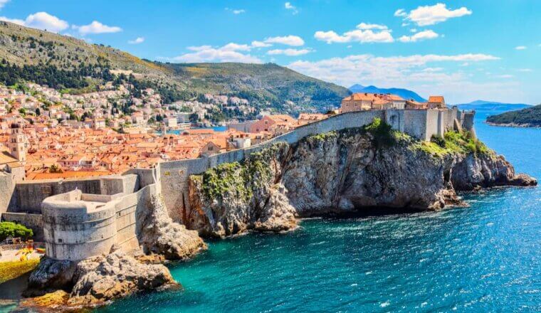 The historic old buildings of Dubrovnik, Croatia perched along the old wall near the beautiful sea