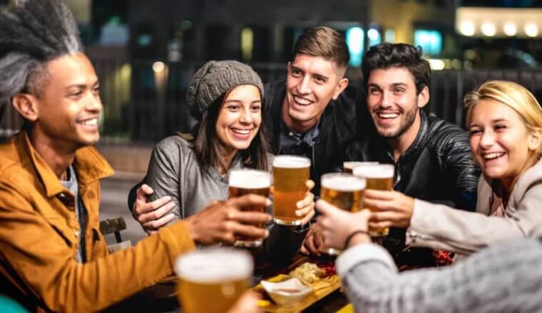 A group of travelers drinking peer at a pub overseas
