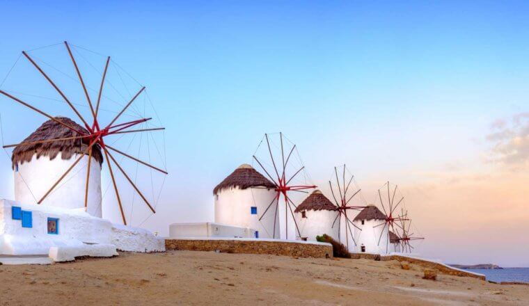 Four windmills at sunset on the island of Mykonos in Greece