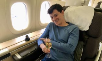 Nomadic Matt enjoying a first class seat while flying around the world