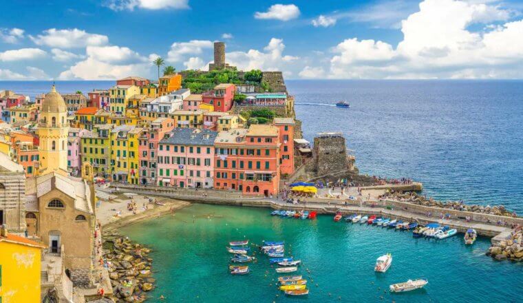 Colorful buildings and harbor filled with boats in the town of Vernazza in the Cinque Terre, Italy