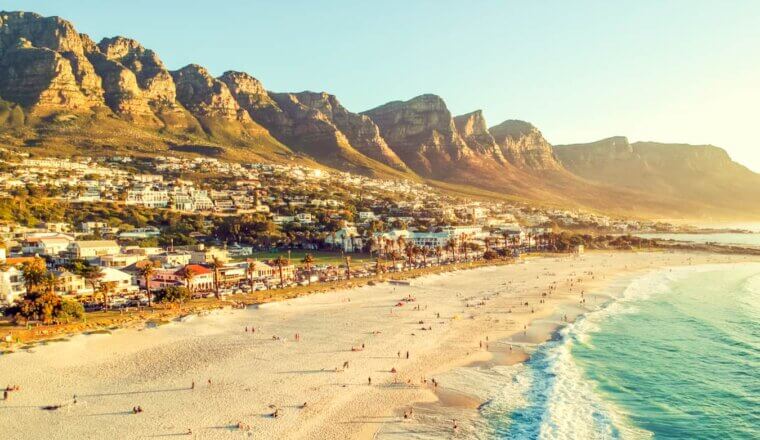 A view overlooking the beautiful beach of Cape Town, South Africa with mountains in the distance