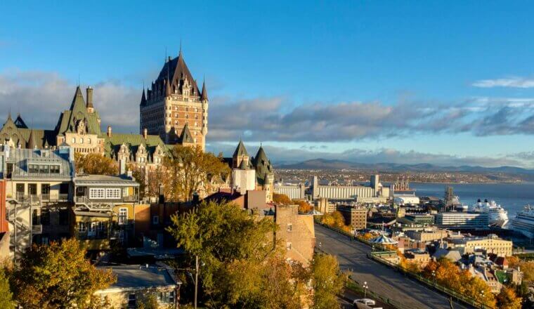 A view over the skyline of Quebec City, Canada with a towering historic chateau in the distance