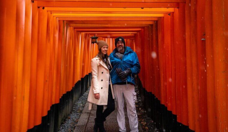 Blogger Kristin Addis of Be My Travel Muse with her partner and baby at Fushimi Inari Shrine in Japan