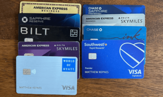 a variety of different credit cards lined up on a wooden table