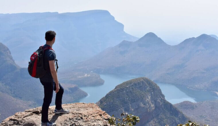 Nomadic Matt, wearing a backpack, out hiking in the beautiful mountains Africa