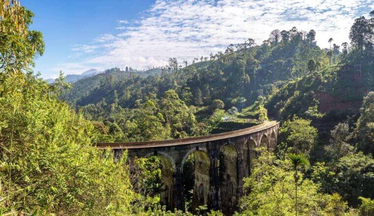 A bright blue sky over the Nine Arches bridge going through the jungle in Sri Lanka