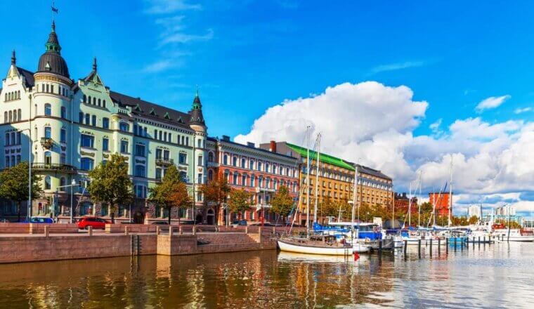 The waterfront of Helsinki, Finland, with sailboats docked and colorful buildings