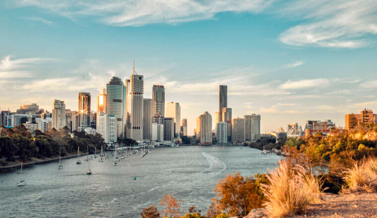 The towering downtown skyline of Brisbane as seen from over the river on a sunny day in Australia