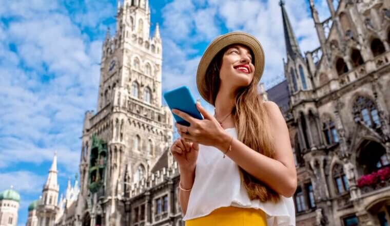 A solo female traveler using her eSIM and smartphone while traveling Europe