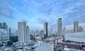 The towering skyline of downtown Bangkok, Thailand with a bright blue sky