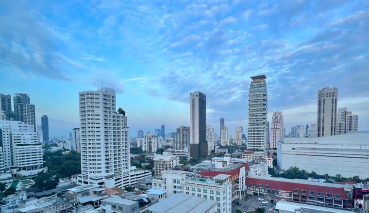 The towering skyline of downtown Bangkok, Thailand with a bright blue sky