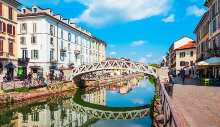 A beautiful bridge across a narrow canal in sunny Milan, Italy